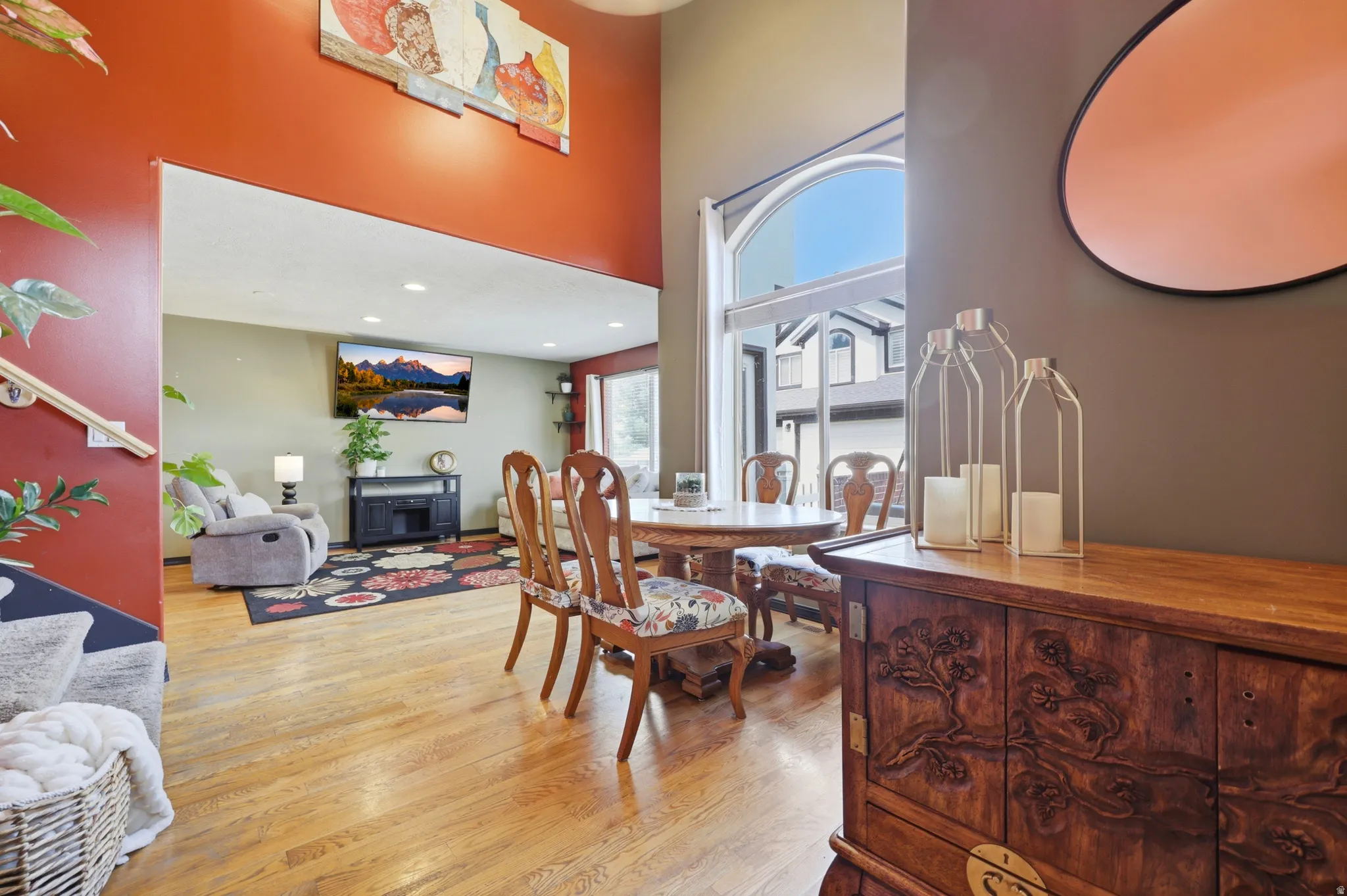 High ceilings featuring an arched window with an exterior view