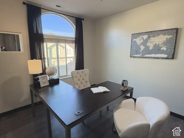 Room featuring wood-finish flooring and an arched window