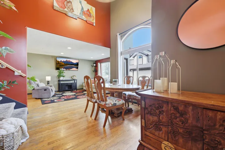 High ceilings featuring an arched window with an exterior view