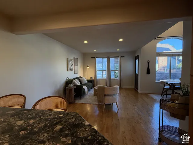 Living area featuring wood-finish flooring, recessed lighting, and expansive windows