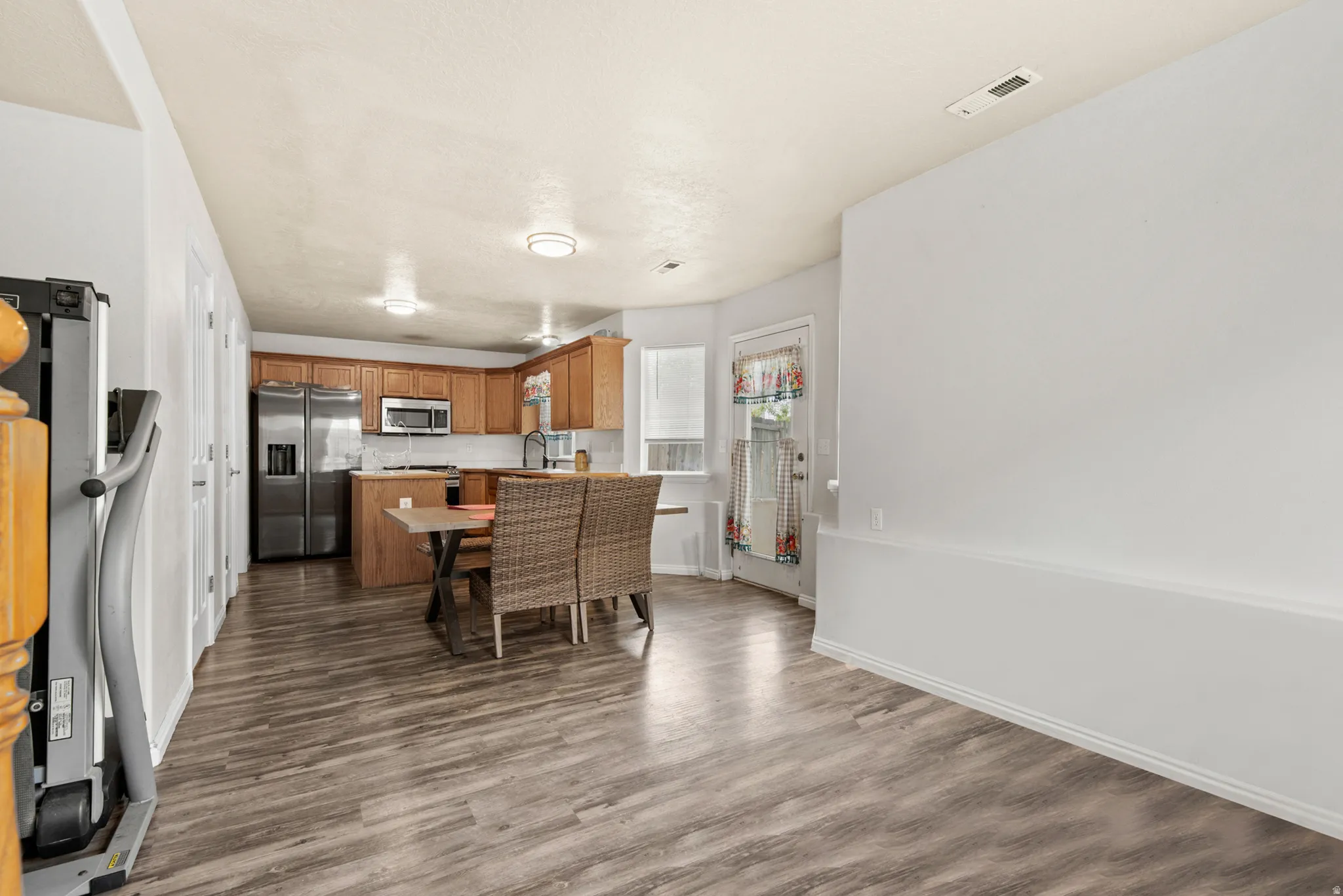 Kitchen dining area featuring wood-finish flooring and a light neutral color palette