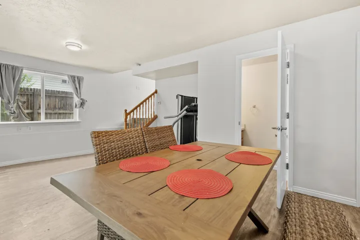 Brightly lit interior space featuring light wood-finish flooring and white painted walls