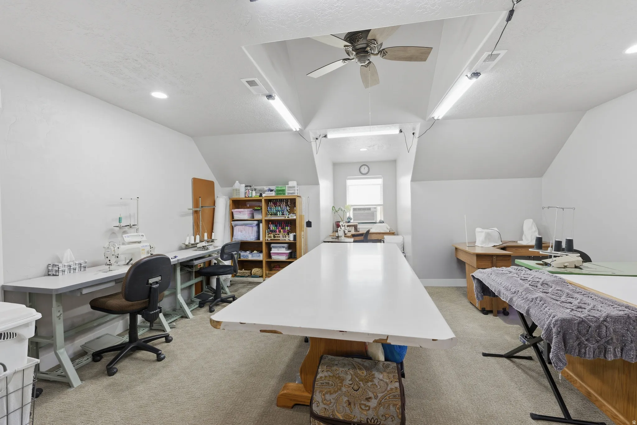 Versatile room featuring an angled ceiling and neutral carpeting