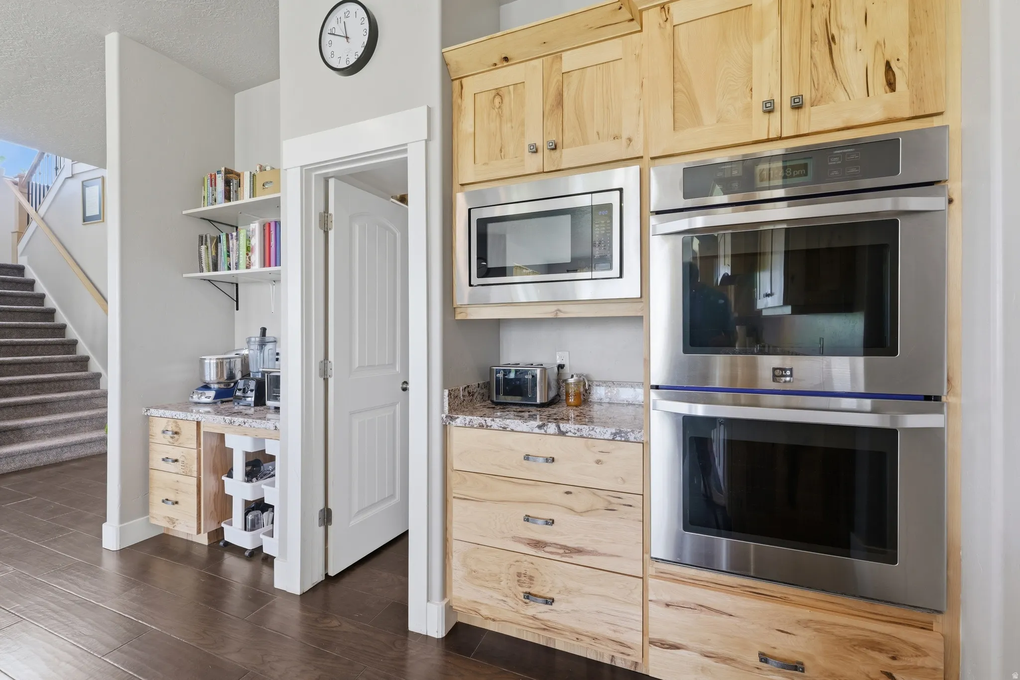 Built-in stainless steel double oven with an adjacent microwave