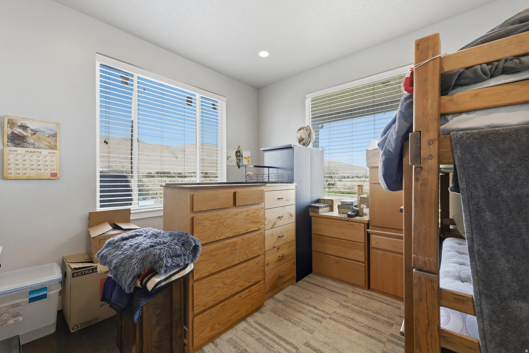 Room featuring two large windows with horizontal blinds, light gray wall paint, and recessed ceiling lighting