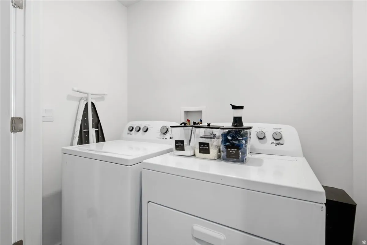 Dedicated laundry area featuring a white washing machine and dryer set