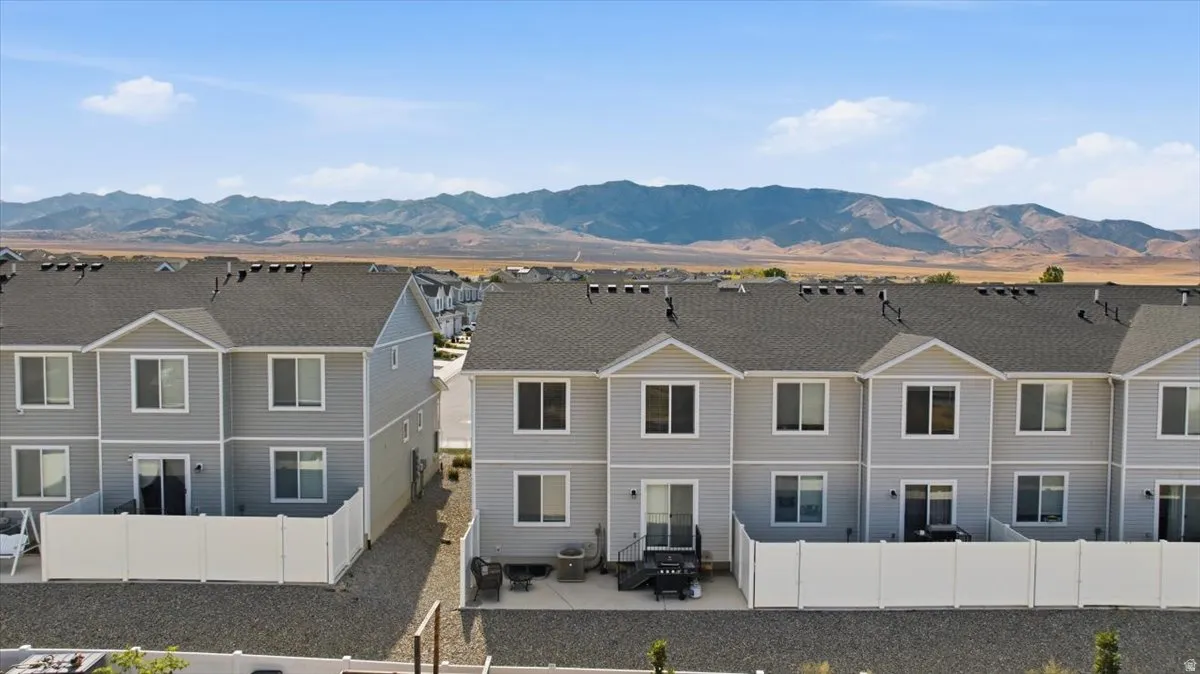 Contemporary townhome exteriors featuring light gray siding and white trim