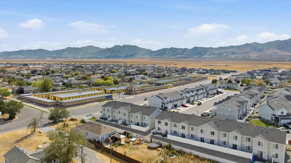 Extensive residential development featuring rows of multi-story townhomes with light-toned siding and dark-toned roofs