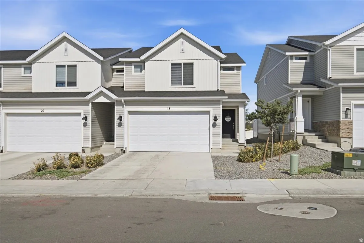 Modern townhome with light gray siding and white trim