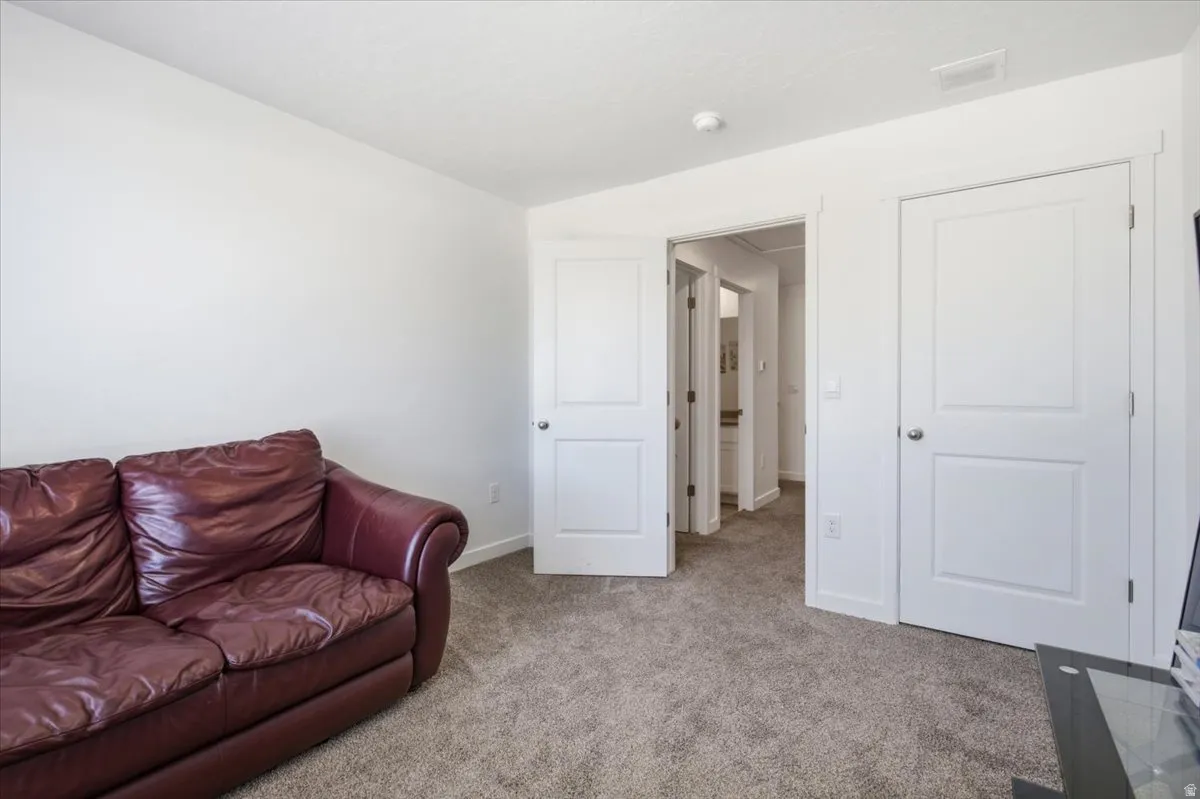 White interior walls with neutral carpeting