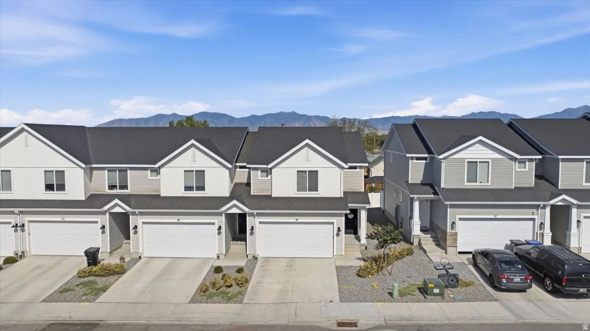 Row of townhomes featuring two-story construction with gabled roofs