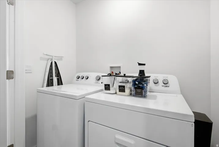 Dedicated laundry area featuring a white washing machine and dryer set