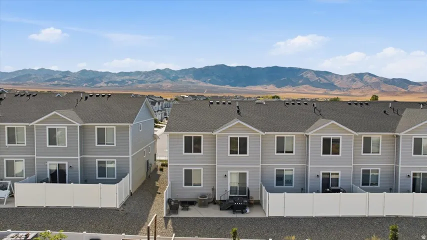 Contemporary townhome exteriors featuring light gray siding and white trim