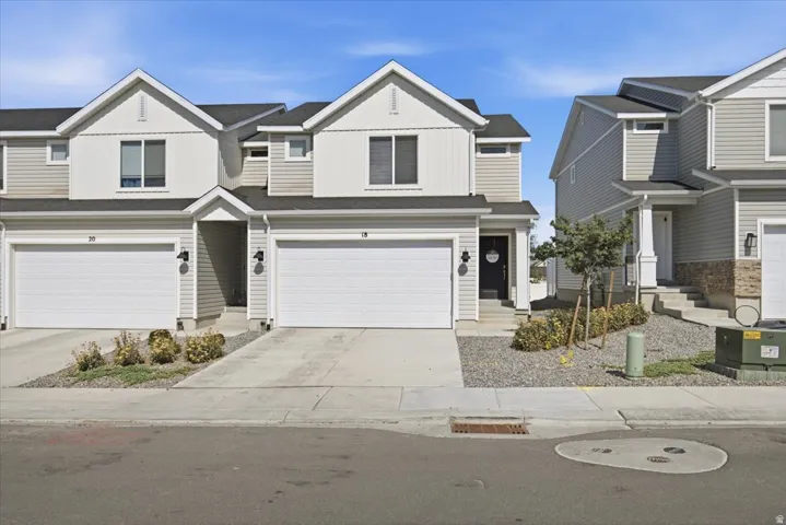 Modern townhome with light gray siding and white trim