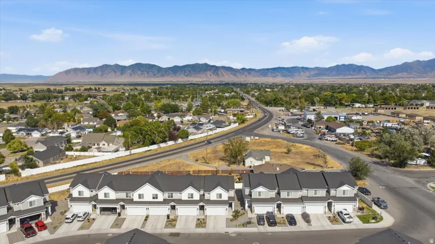Modern townhome community featuring two-story residences with attached garages and paved driveways