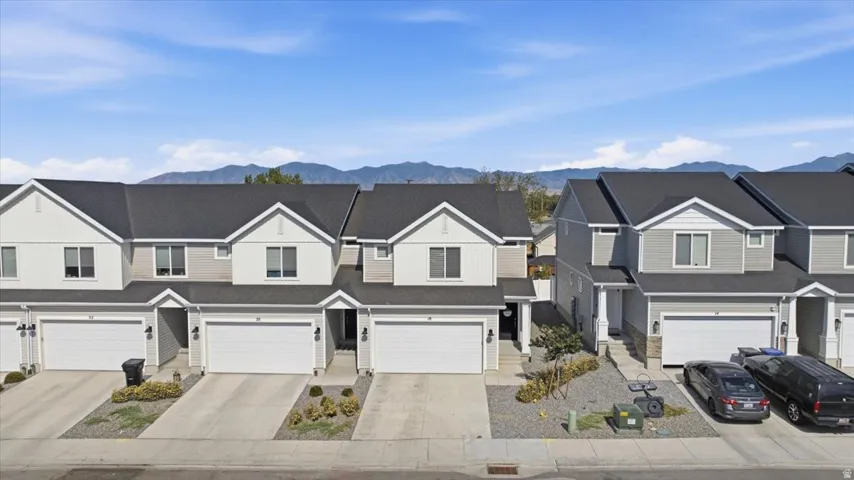 Row of townhomes featuring two-story construction with gabled roofs