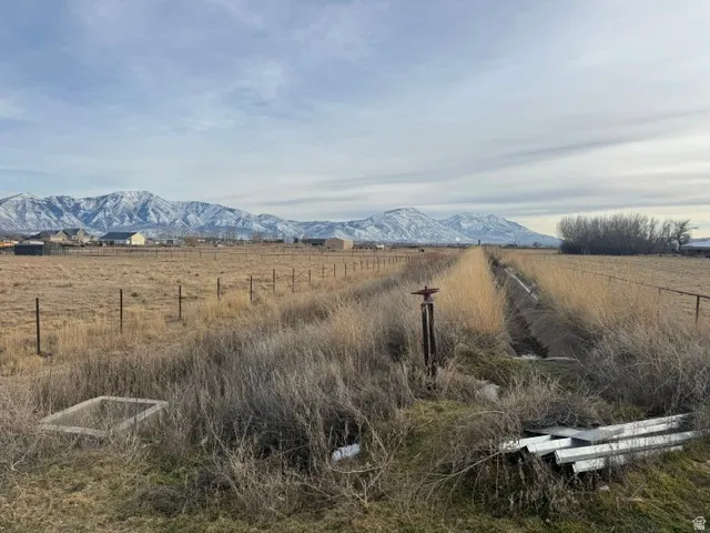 Expansive land parcel featuring natural grasses and perimeter fencing