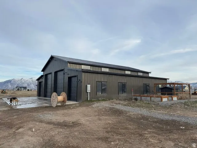 Metal-sided structure with a dark roof and multiple overhead doors