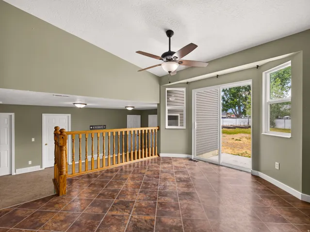 Tiled flooring extending to a sliding glass door offering direct patio access