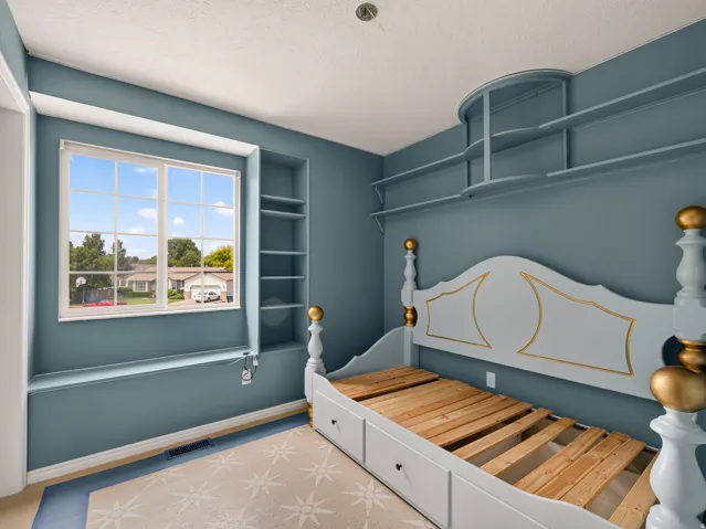 Built-in shelving and window seat complement the light blue walls