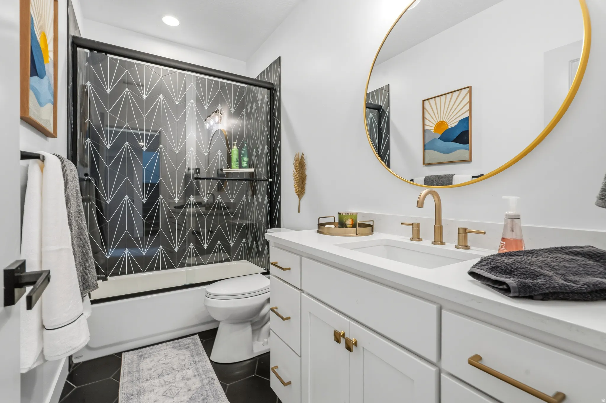 Bathroom featuring a white vanity with gold-tone hardware, a rectangular undermount sink, and a white countertop