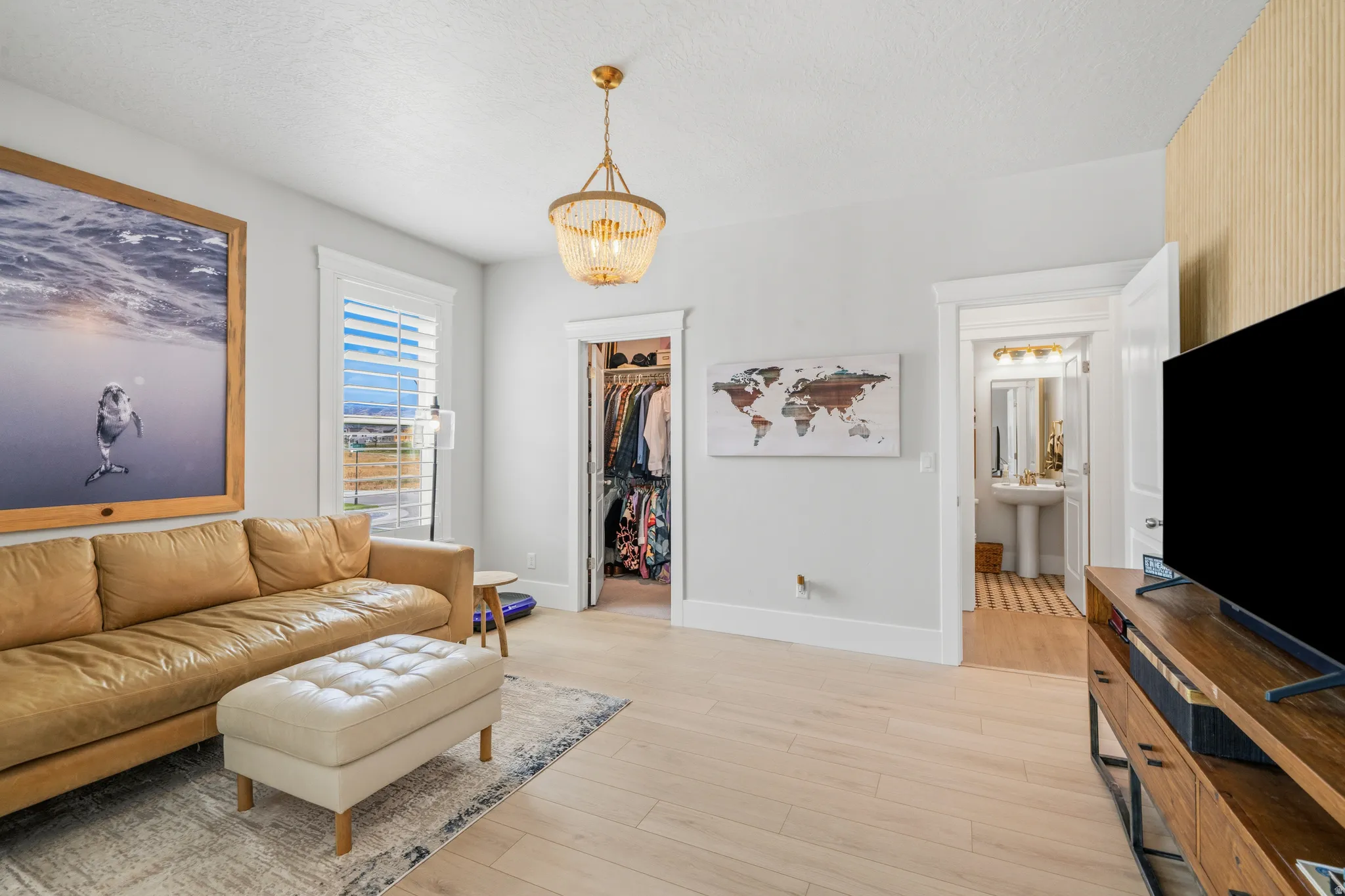 Light wood-finish flooring complements the neutral wall tones