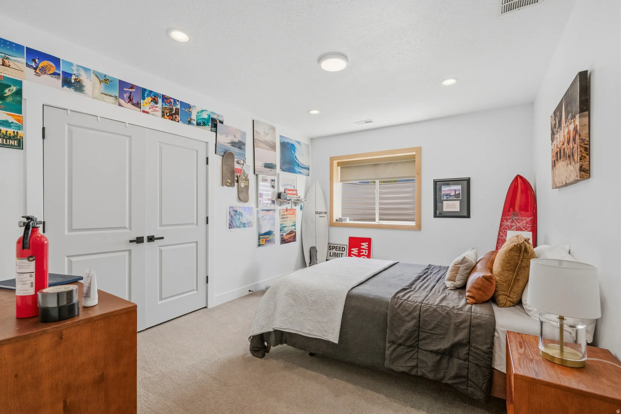 Bedroom featuring neutral wall paint, recessed lighting, double closet doors with matte black hardware, a wood-framed window with blinds, and carpet flooring