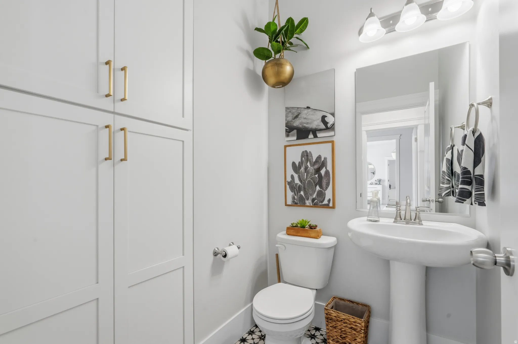 White pedestal sink with a contemporary faucet and mirror