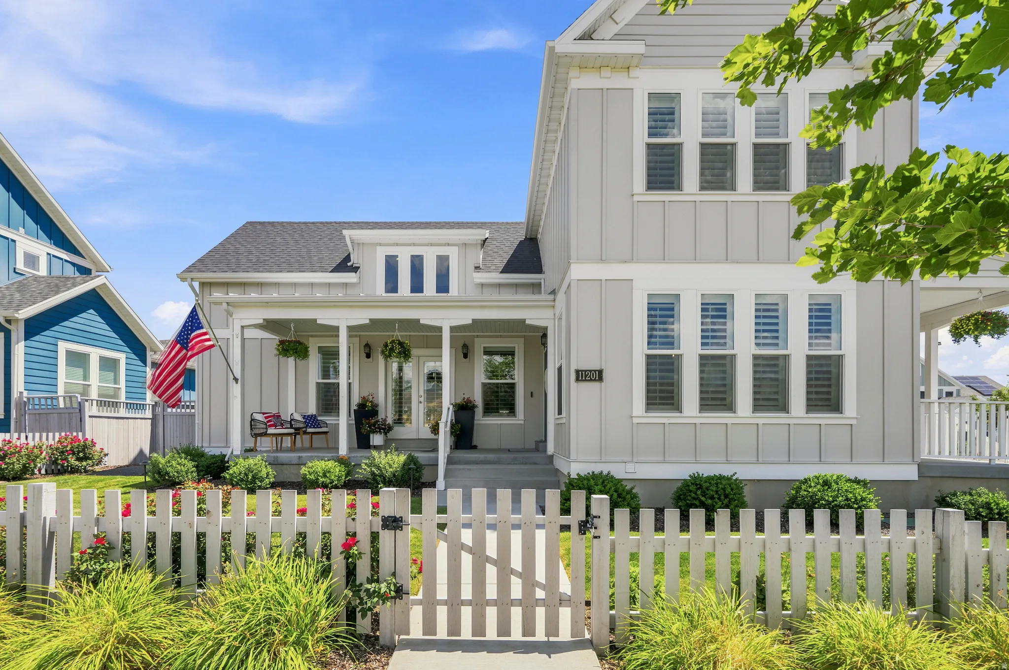 Light gray board-and-batten siding with white trim
