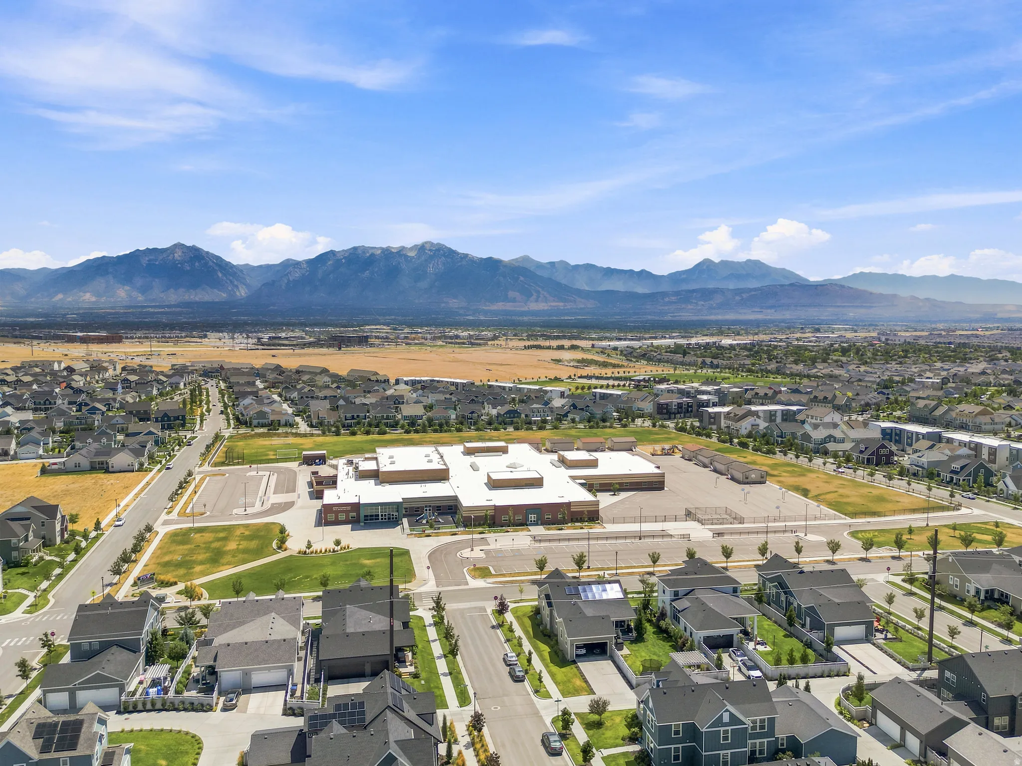 Expansive residential area featuring numerous single-family homes with gray roofs and varied architectural styles