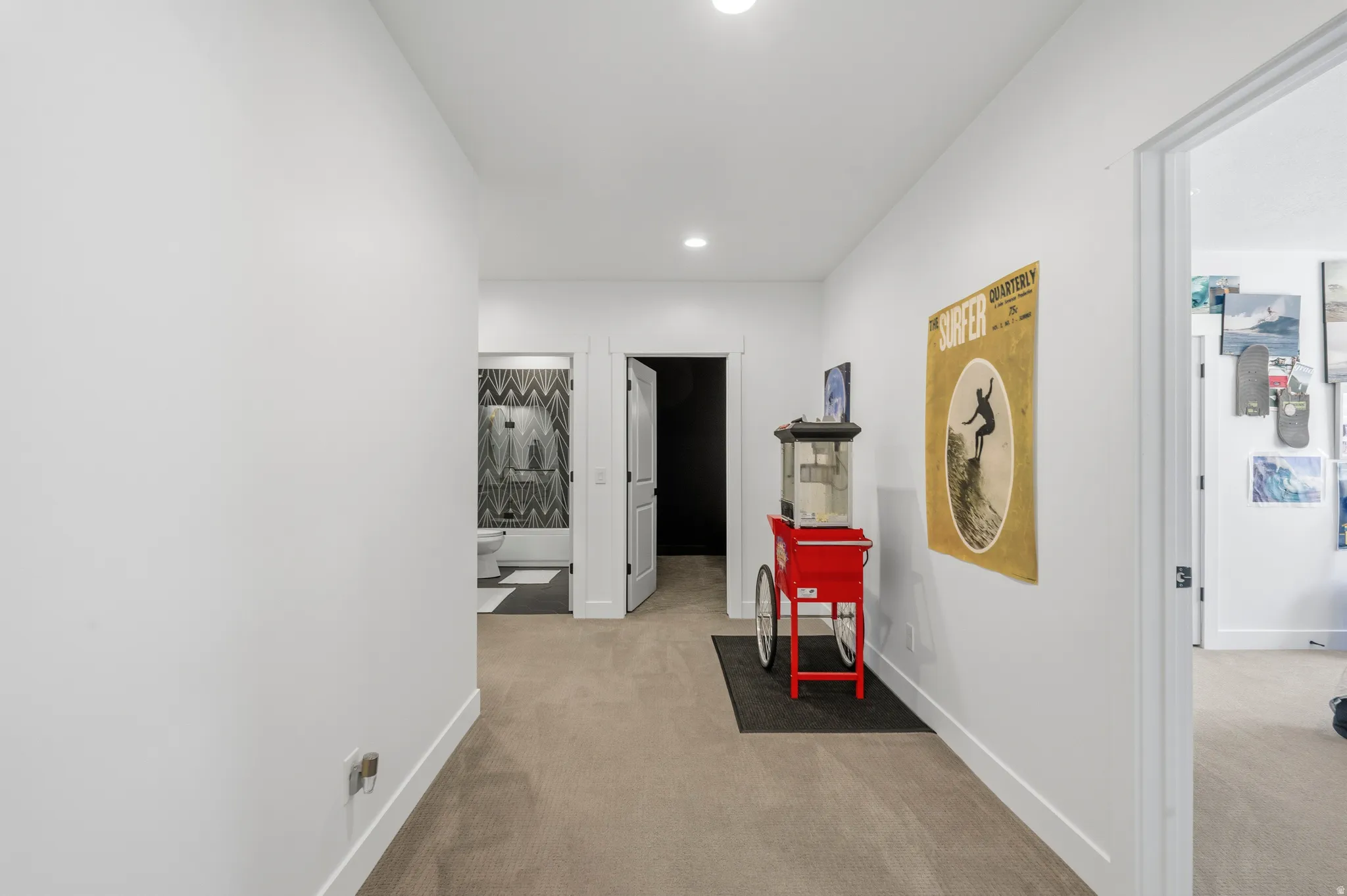 Interior hallway featuring recessed lighting, a neutral carpeted floor, and white baseboards