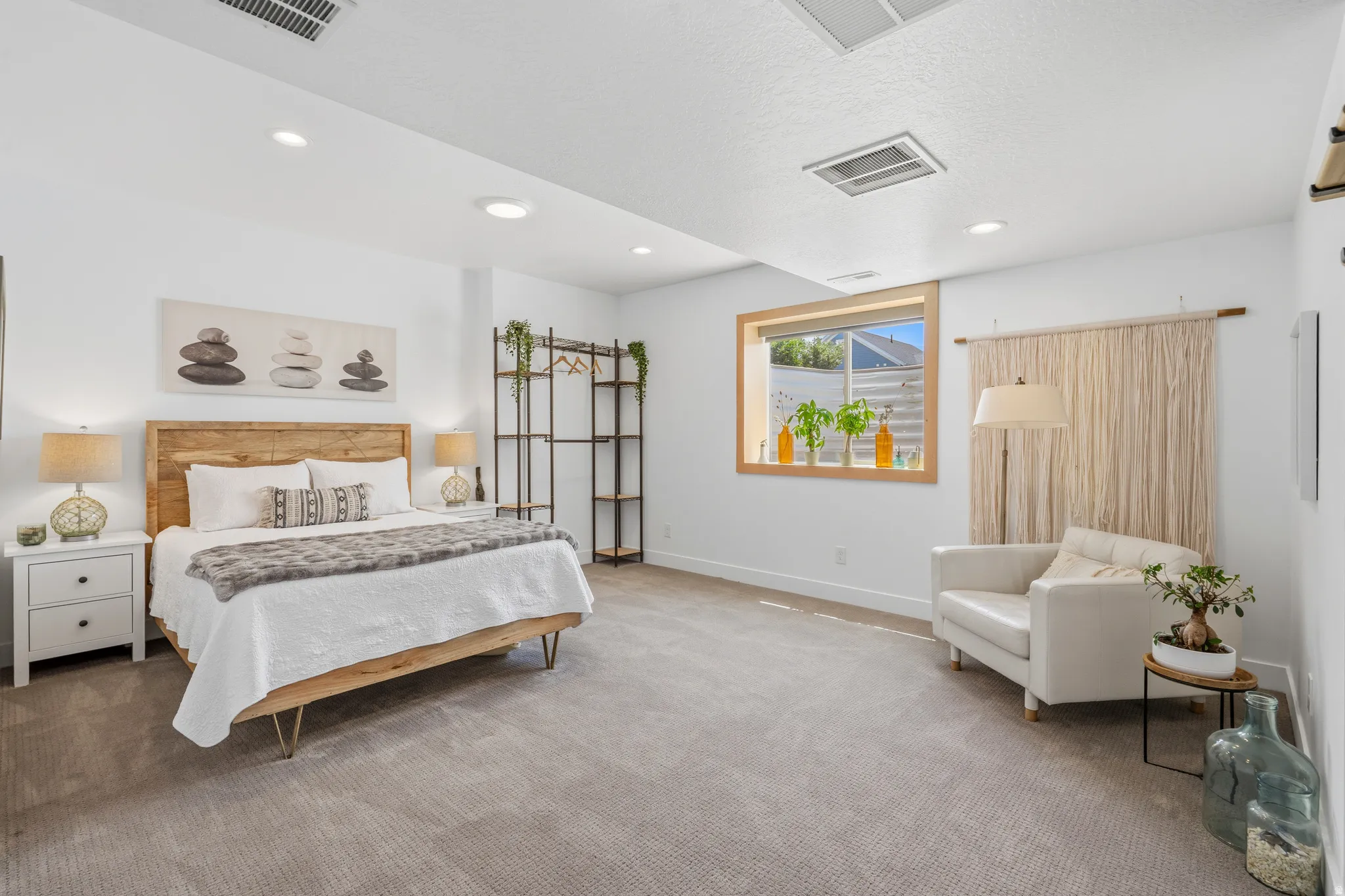 Carpeted bedroom with recessed lighting and a wood-framed window