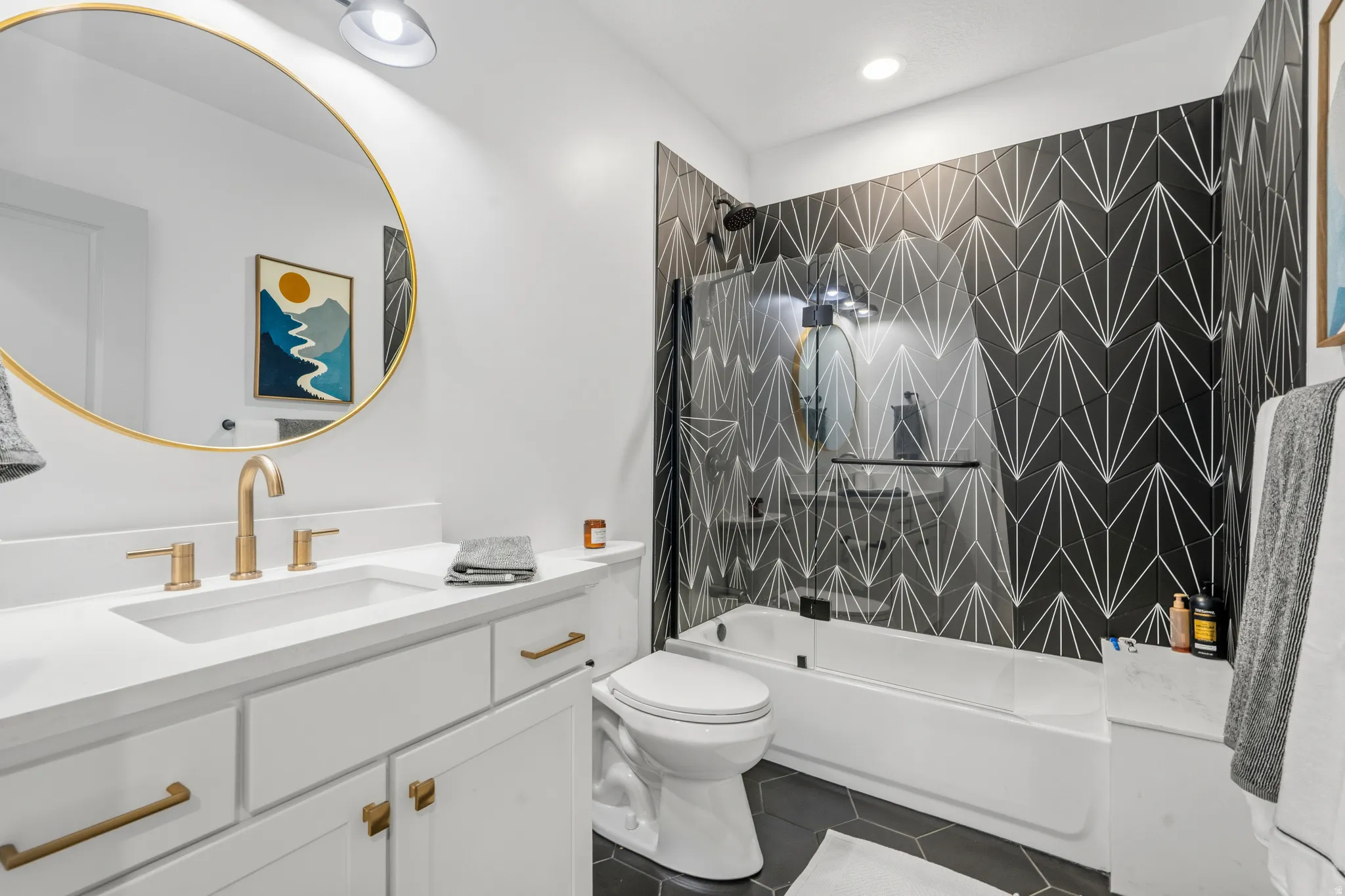 Modern bathroom featuring a white vanity with a rectangular undermount sink and brass-finish fixtures