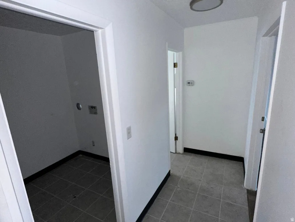Dedicated laundry area with utility hookups and tile flooring
