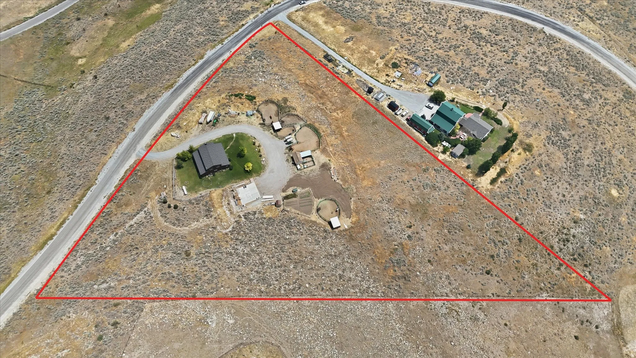 Expansive property featuring two distinct structures on a large, irregularly shaped parcel