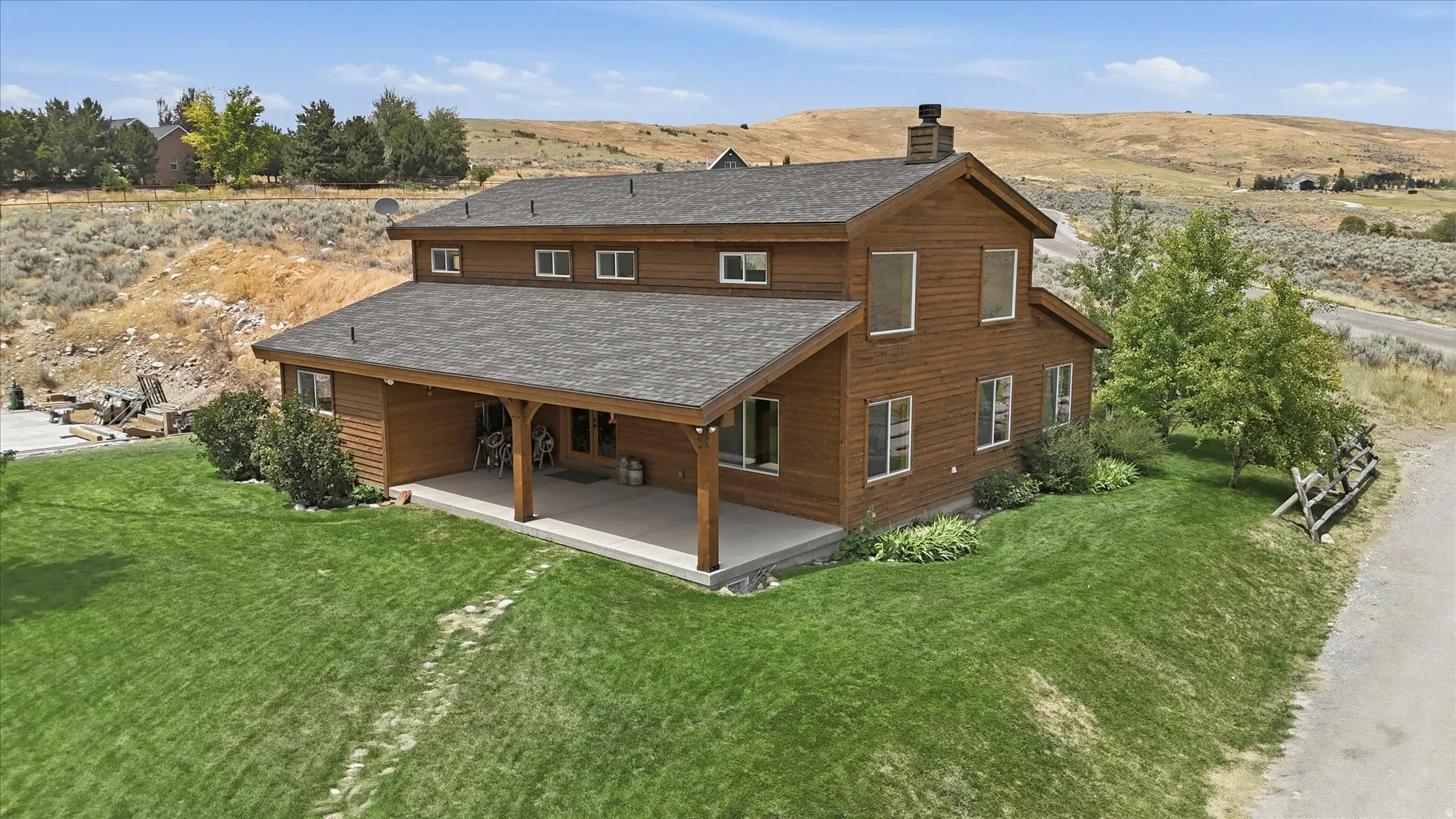 Two-story residence featuring wood siding and a covered patio