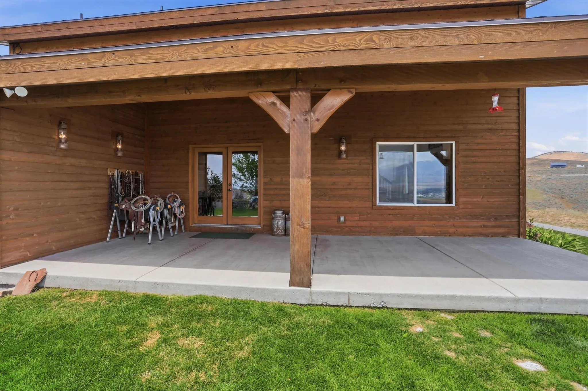 Covered patio featuring wood siding and a concrete surface