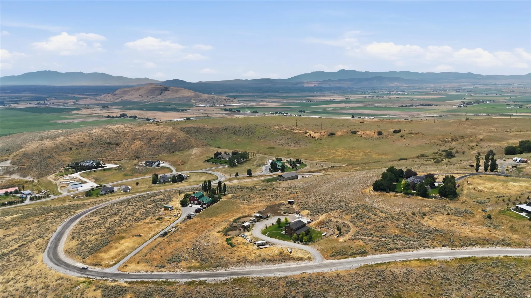 Expansive rural landscape featuring winding roads and scattered residential properties