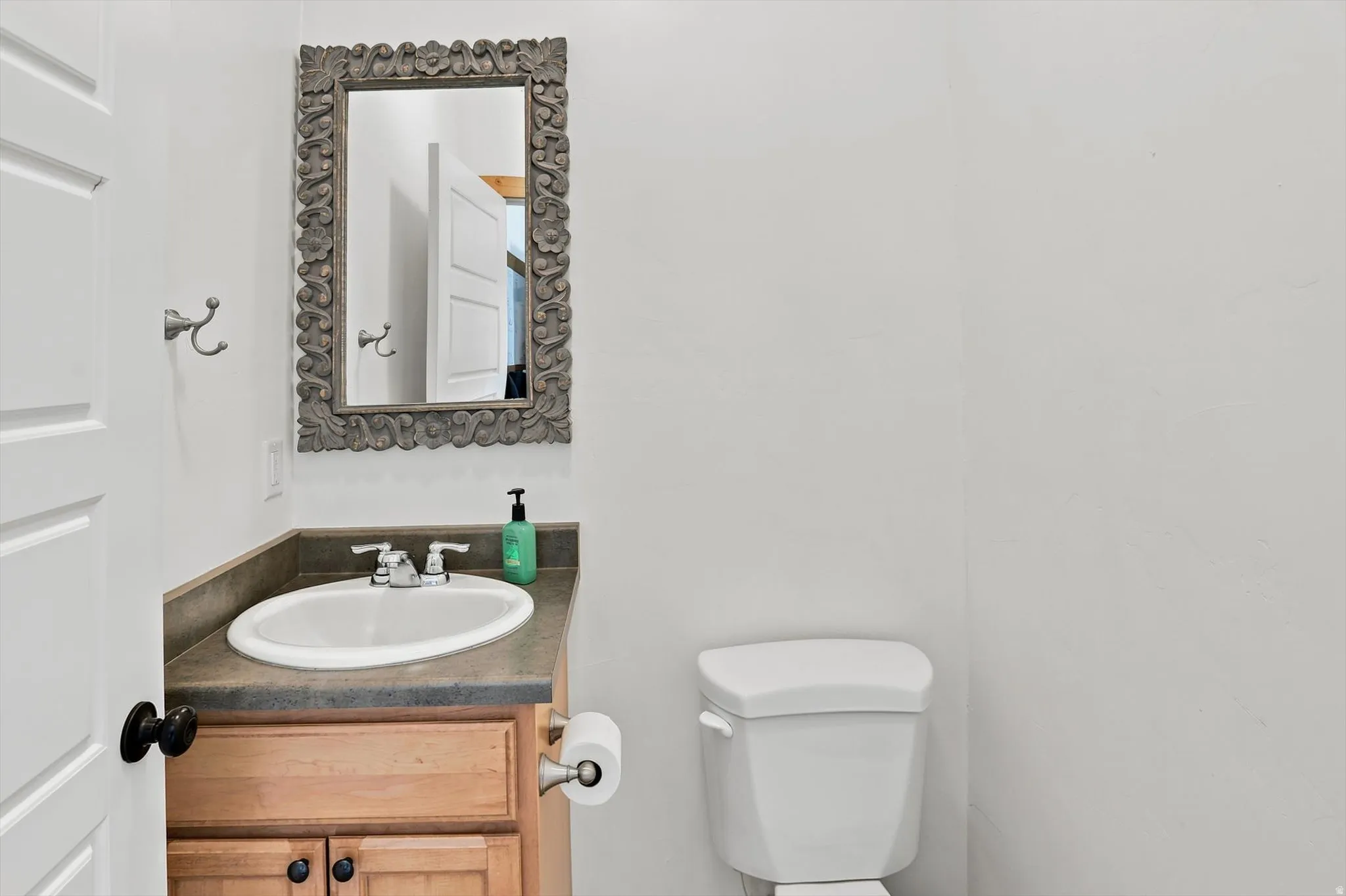 Vanity with an integrated oval sink, countertop, and wood-finish cabinetry