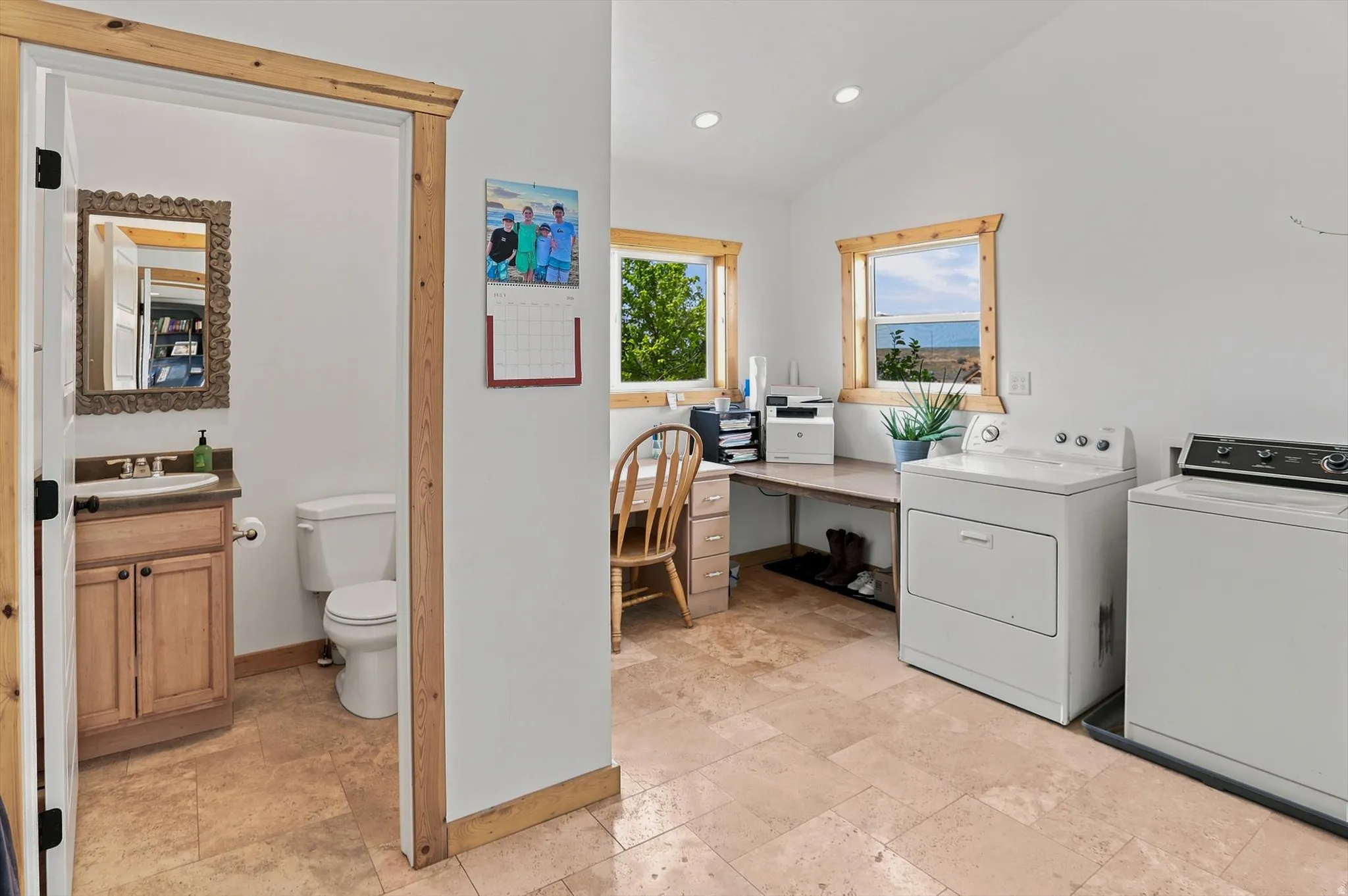 Main Floor Laundry Room and Half bath. Versatile utility room featuring wood-finish trim, recessed lighting, and tiled flooring