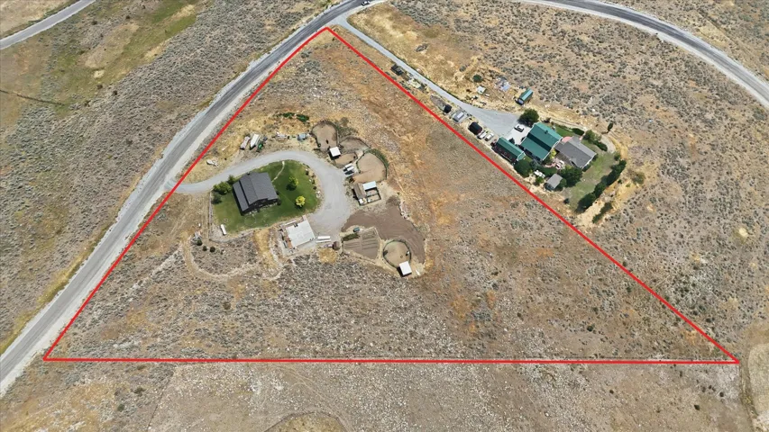 Expansive property featuring two distinct structures on a large, irregularly shaped parcel