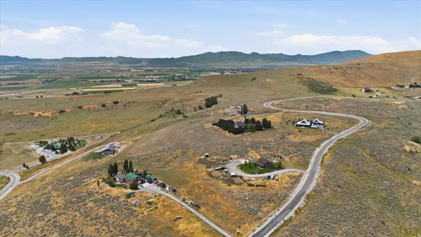 Expansive rural landscape featuring winding roads and scattered residential properties
