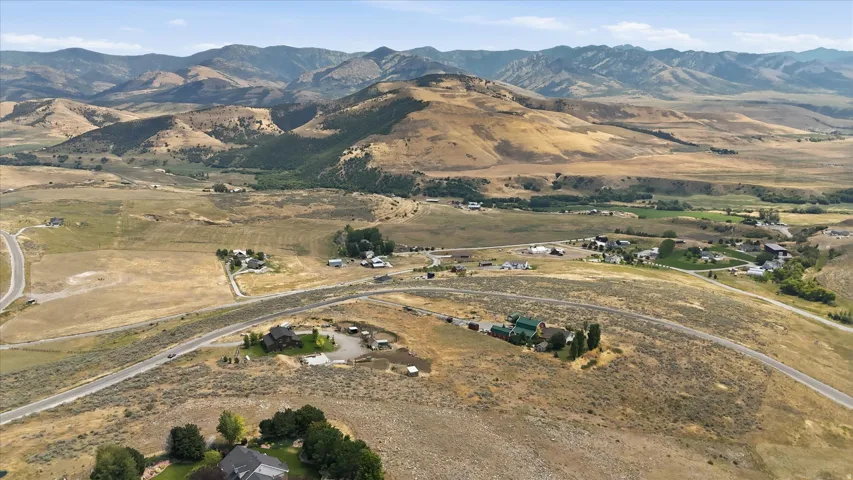 Expansive rural landscape featuring rolling hills and distant mountains