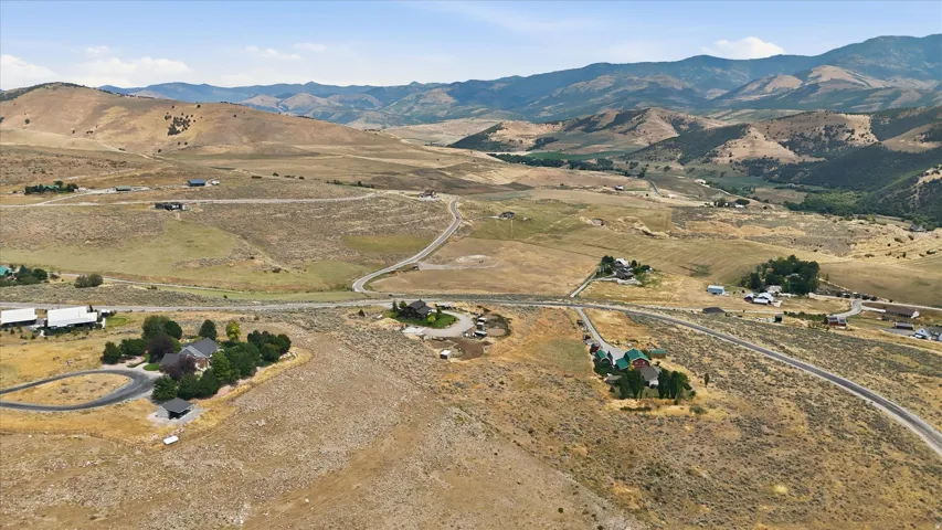 Expansive rural terrain featuring multiple properties with gravel and unpaved roads