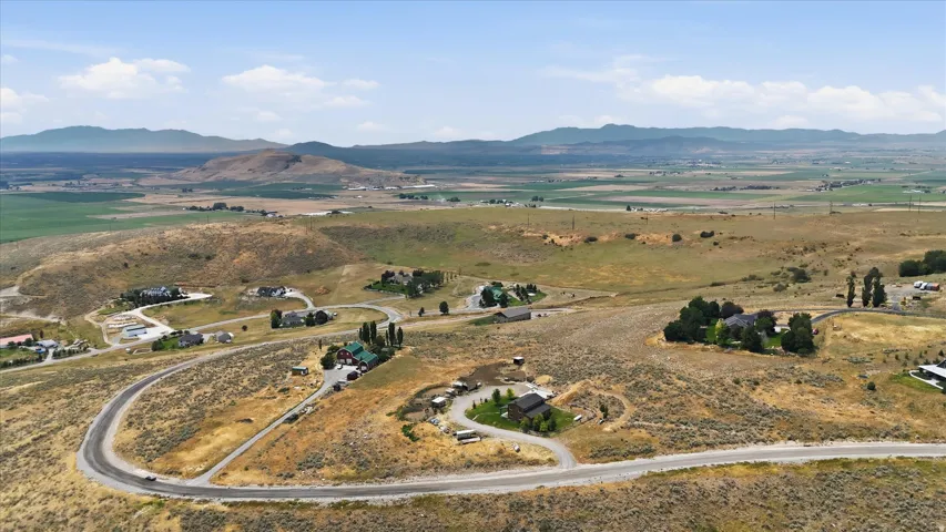 Expansive rural landscape featuring winding roads and scattered residential properties