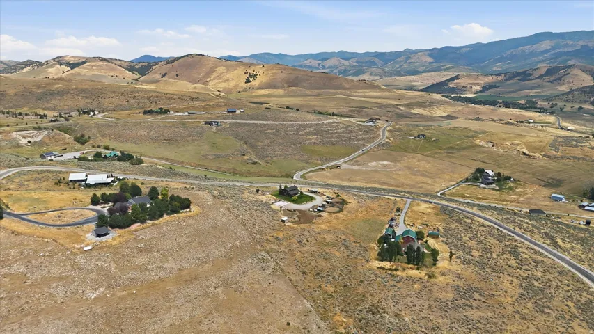 Expansive rural landscape featuring winding roads and distant mountainous terrain