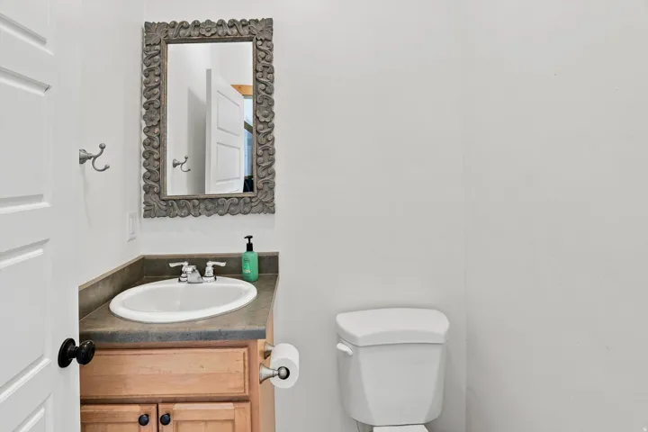 Vanity with an integrated oval sink, countertop, and wood-finish cabinetry