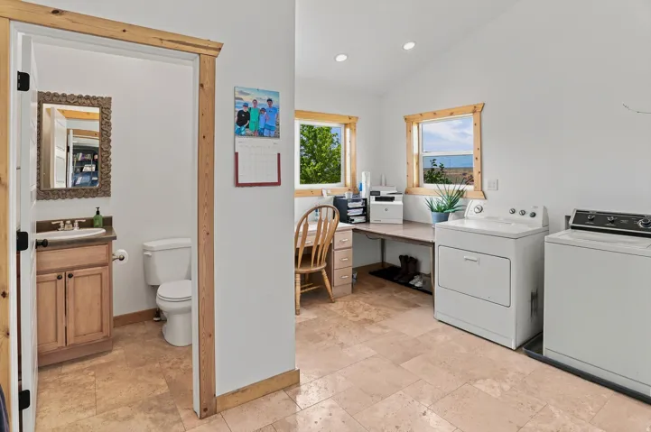 Main Floor Laundry Room and Half bath. Versatile utility room featuring wood-finish trim, recessed lighting, and tiled flooring