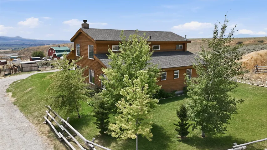 Wood-sided residence with multiple windows set on a green lawn