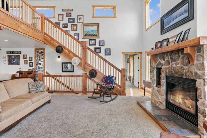 Stone-faced fireplace with a wood mantel and tile hearth